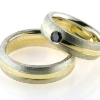 Billede af 1 par vielsesringe, damering fattet sort brill. 0,20 ct.  925s og 18 kt.